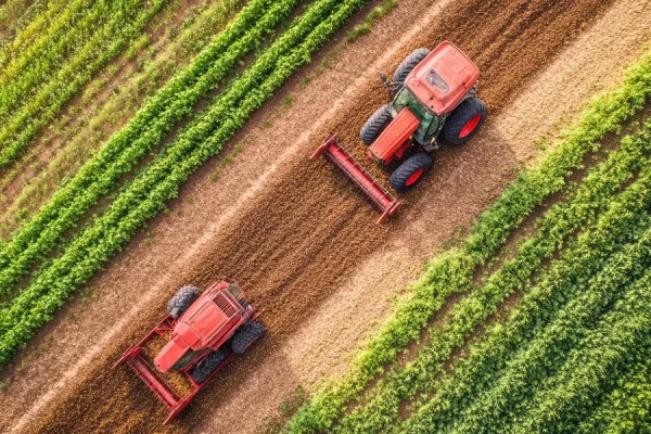 red-tractor-is-driving-through-field-with-tractor